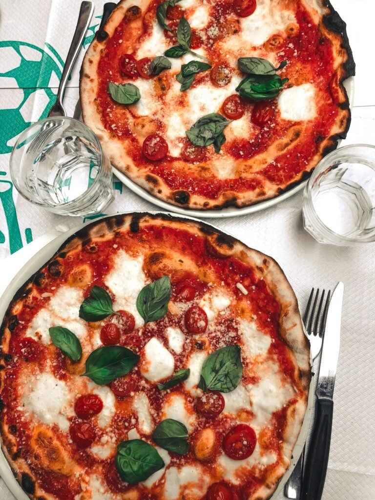 Two delicious pizzas topped with mozzarella and basil, perfect for a tasty meal.